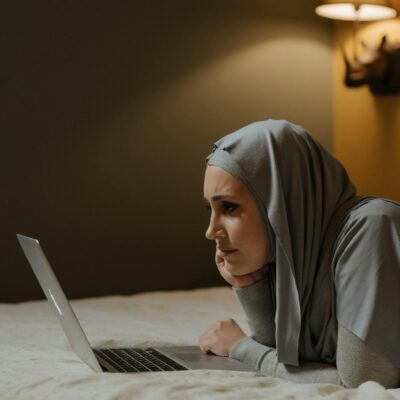 Woman in Gray Hijab Using Macbook Air